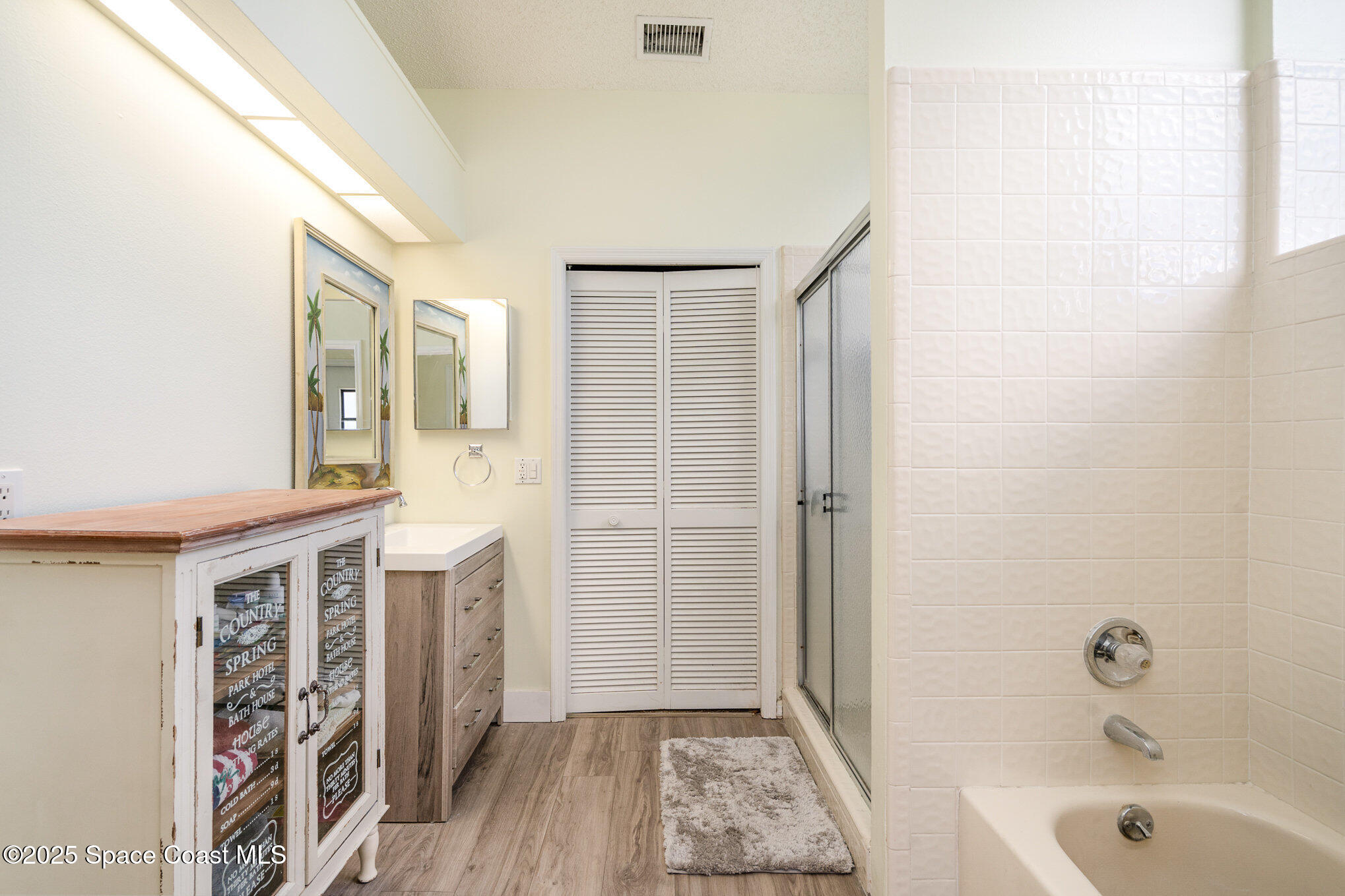 313 Pine Ridge Lane Melbourne, FL 32940 - Photo 20 of 28 a bathroom with a bathtub and a shower