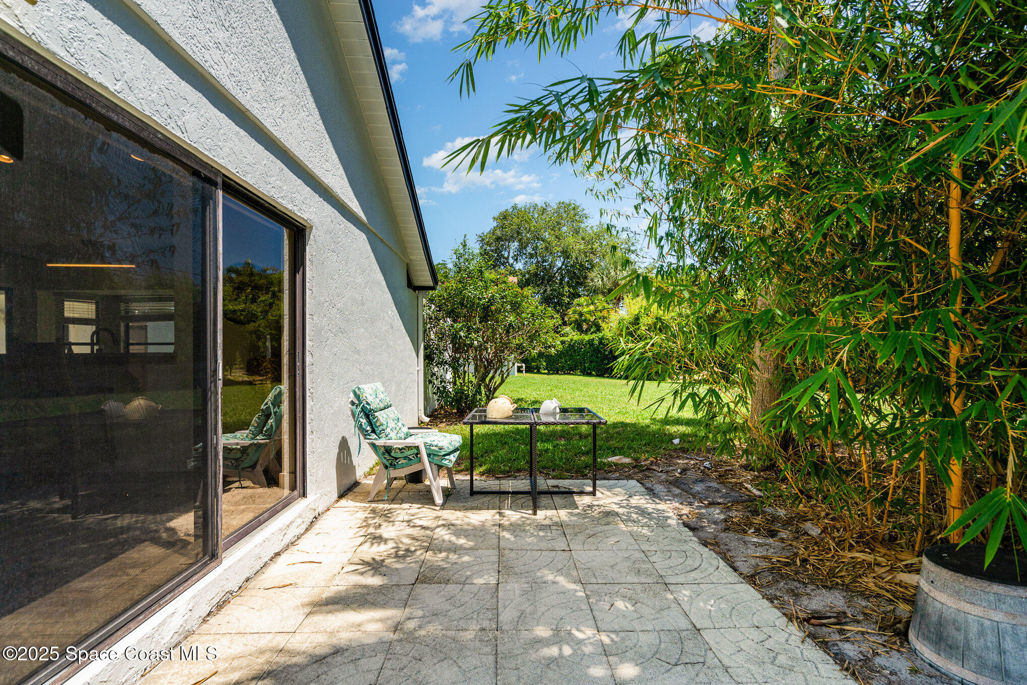 313 Pine Ridge Lane Melbourne, FL 32940 - Photo 25 of 28 a view of a chairs and table in backyard of the house