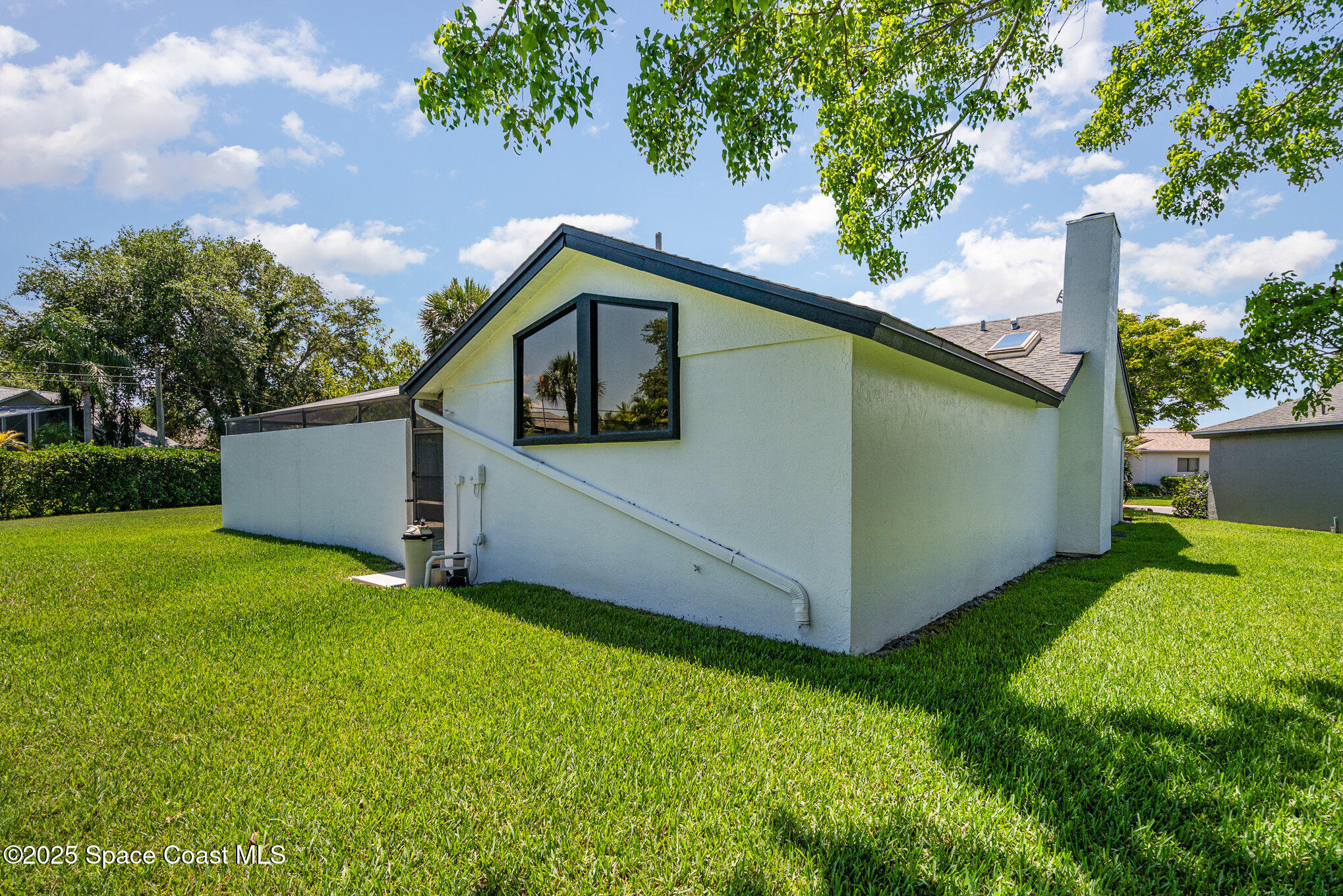 313 Pine Ridge Lane Melbourne, FL 32940 - Photo 26 of 28 a view of a backyard with a house and a park