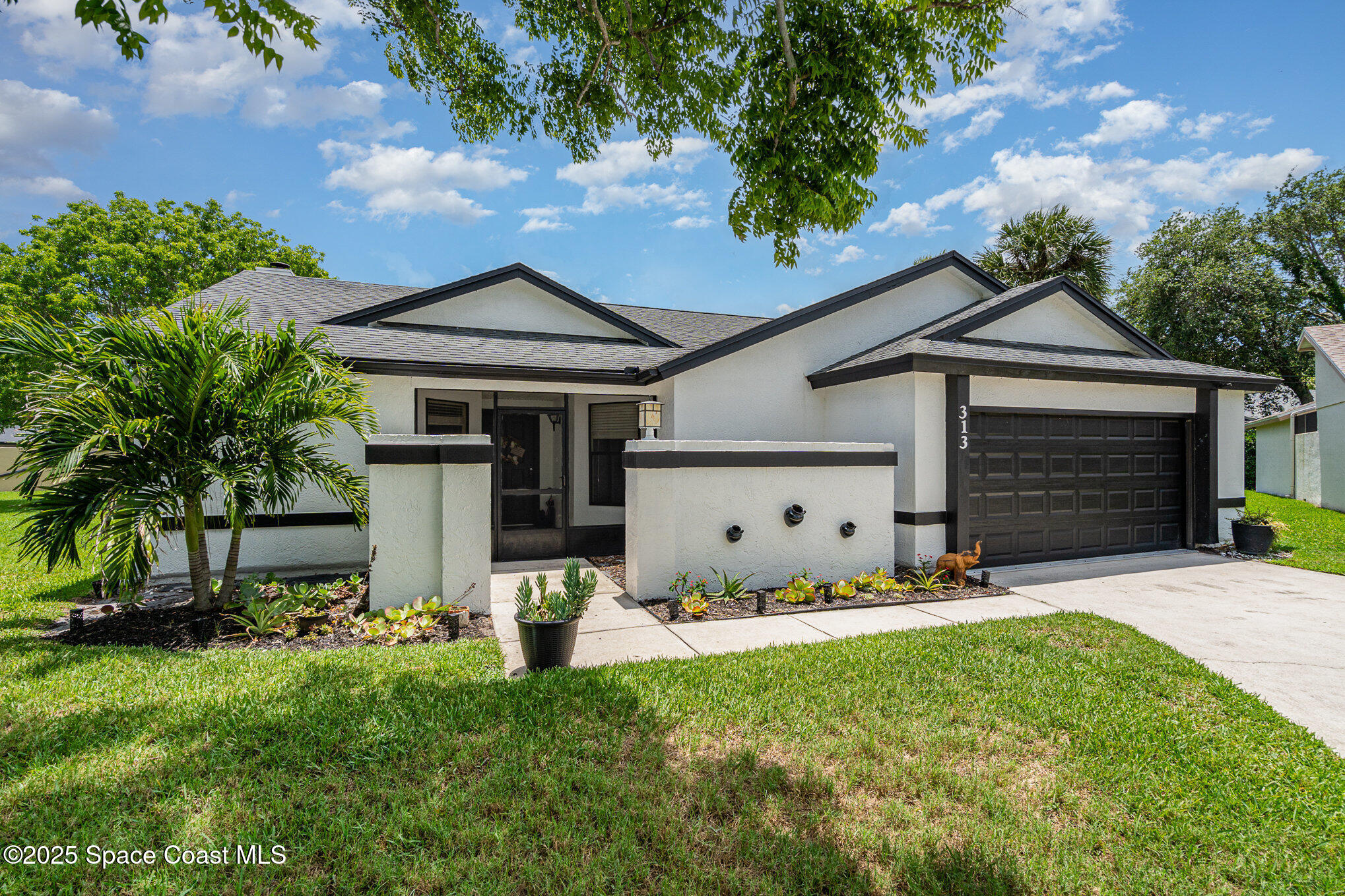 313 Pine Ridge Lane Melbourne, FL 32940 - Photo 3 of 28 a front view of house with yard