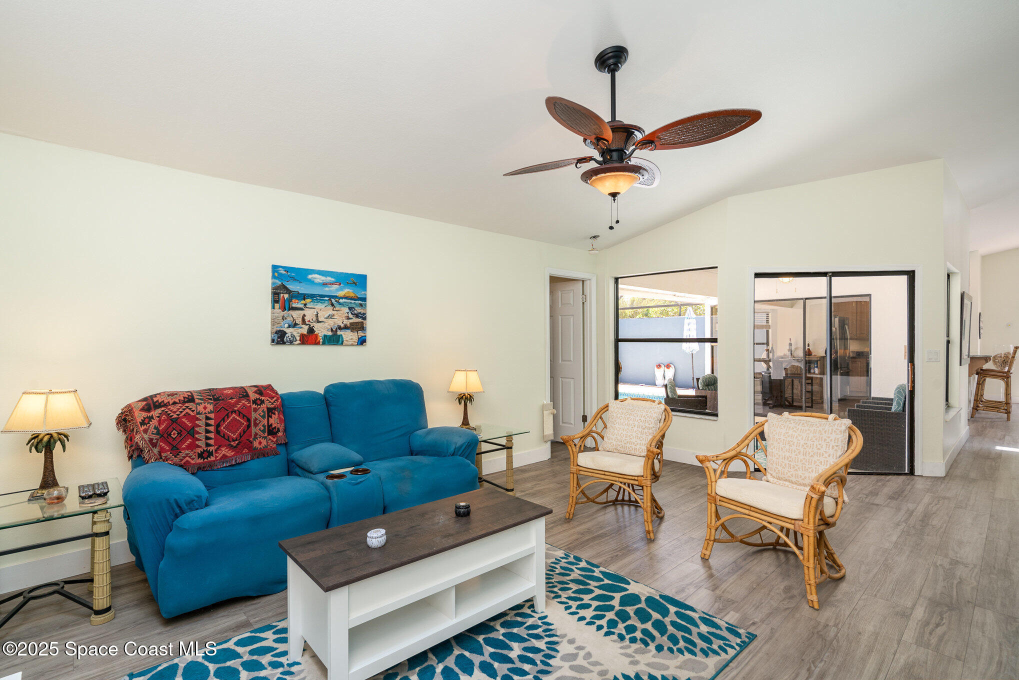 313 Pine Ridge Lane Melbourne, FL 32940 - Photo 6 of 28 a living room with furniture a rug and a chandelier