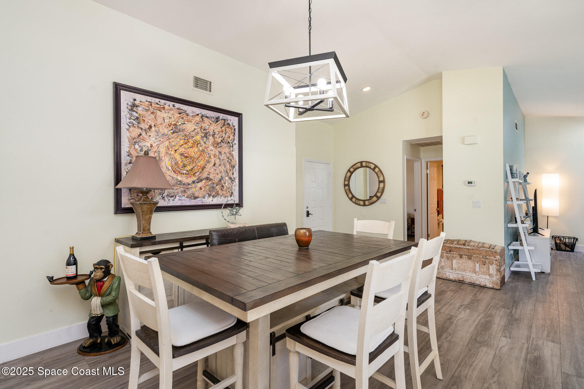 313 Pine Ridge Lane Melbourne, FL 32940 - Photo 7 of 28 a view of a dining room with furniture wooden floor and a chandelier