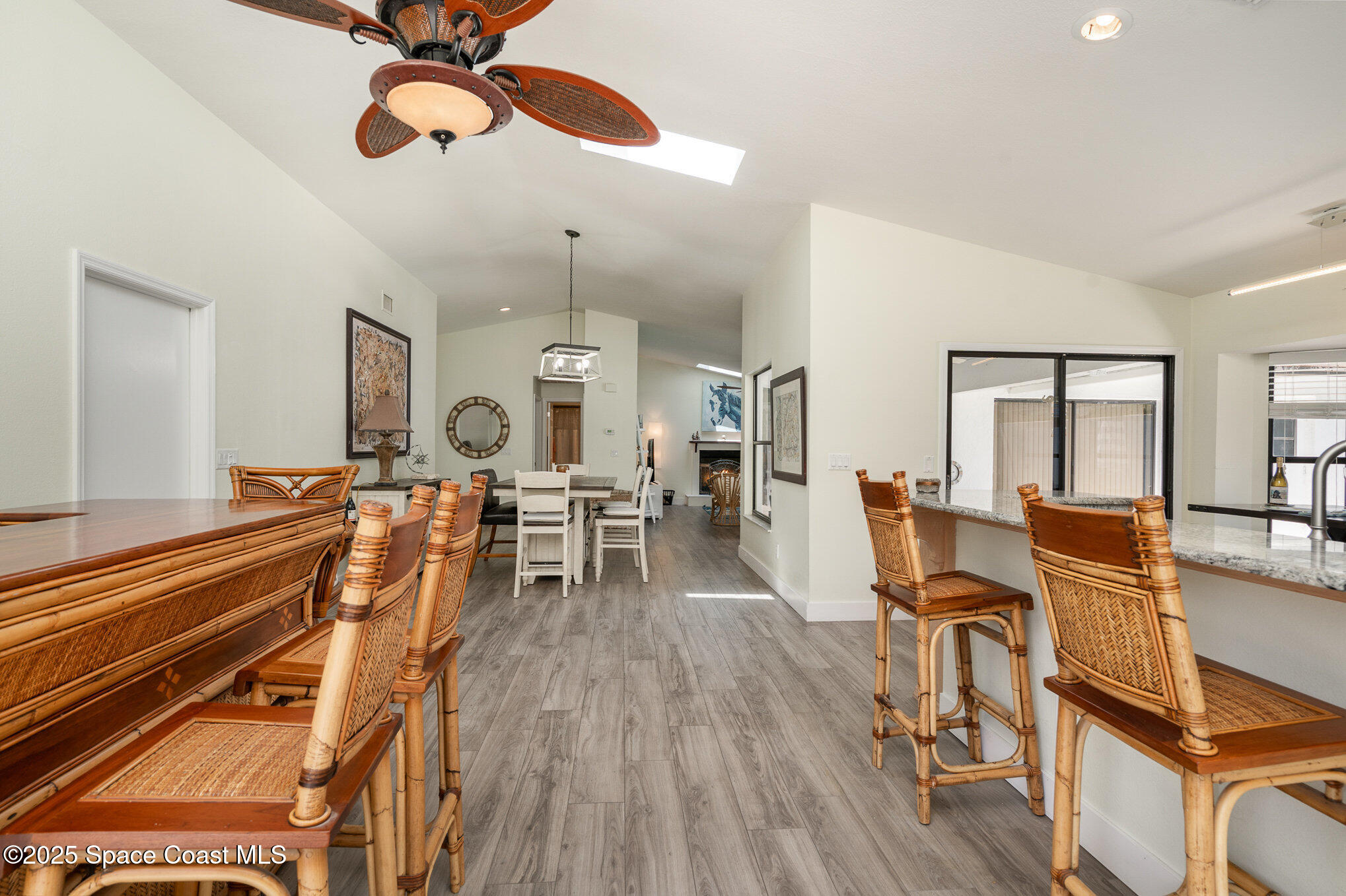 313 Pine Ridge Lane Melbourne, FL 32940 - Photo 9 of 28 a living room with furniture a dining table and chairs with wooden floor