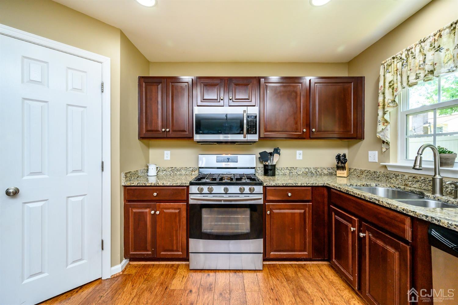 65 Lamp Post Drive Barnegat, NJ 08005 - Photo 12 of 36 a kitchen with stainless steel appliances granite countertop wooden cabinets and a stove top oven