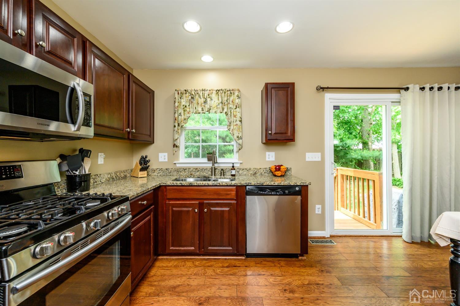 65 Lamp Post Drive Barnegat, NJ 08005 - Photo 13 of 36 a kitchen with stainless steel appliances granite countertop a stove a sink and a microwave