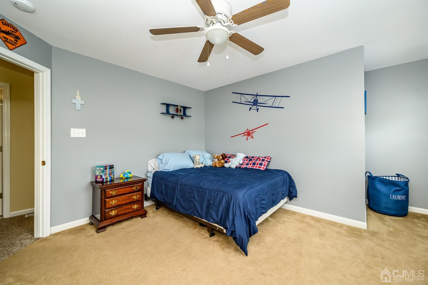 65 Lamp Post Drive Barnegat, NJ 08005 - Photo 19 of 36 a bedroom with a bed and a ceiling fan