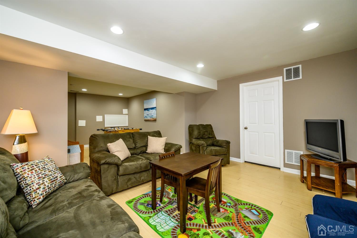 65 Lamp Post Drive Barnegat, NJ 08005 - Photo 30 of 36 a living room with furniture and a flat screen tv