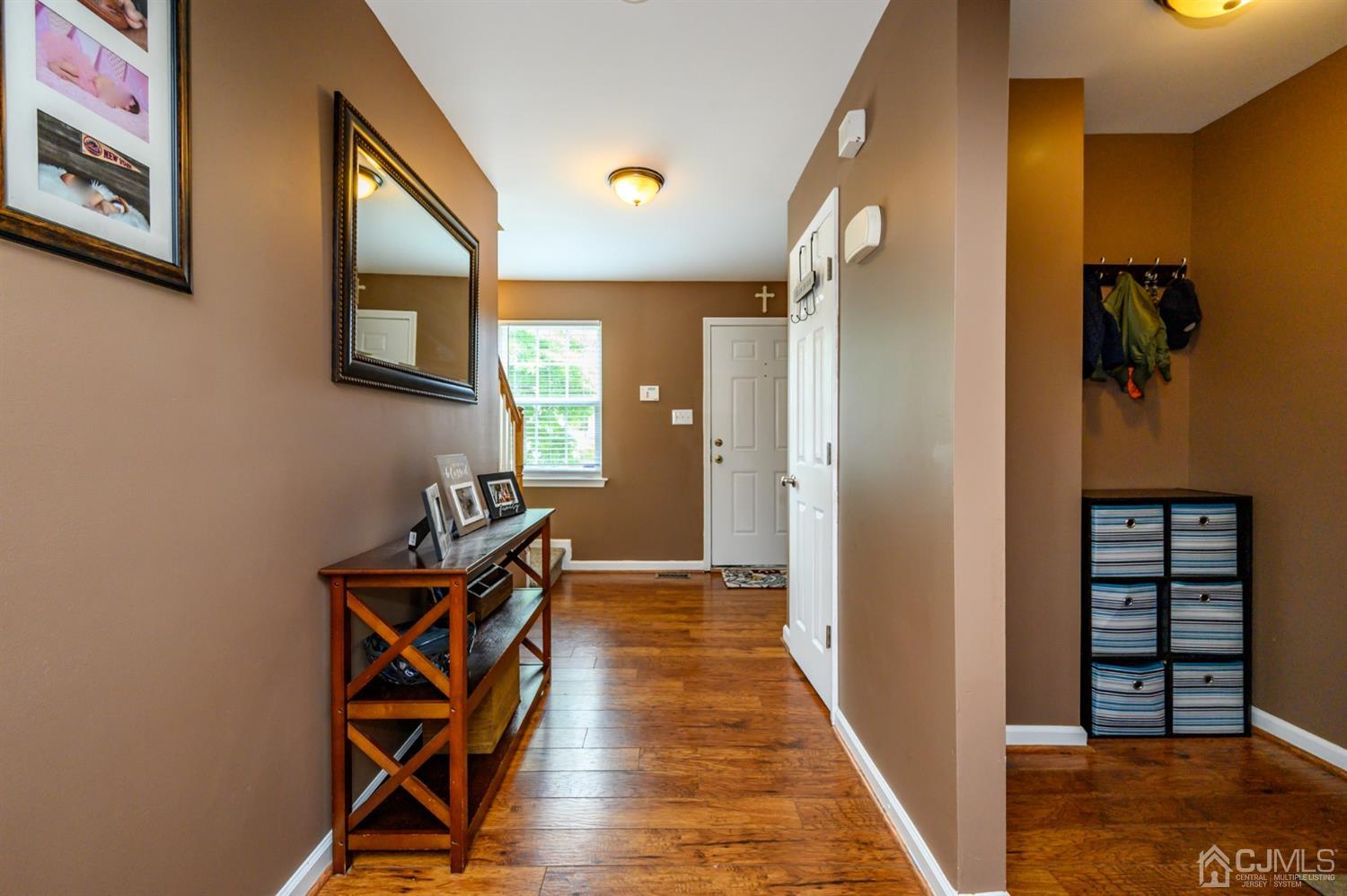65 Lamp Post Drive Barnegat, NJ 08005 - Photo 4 of 36 a view of a hallway with wooden floor and a workspace