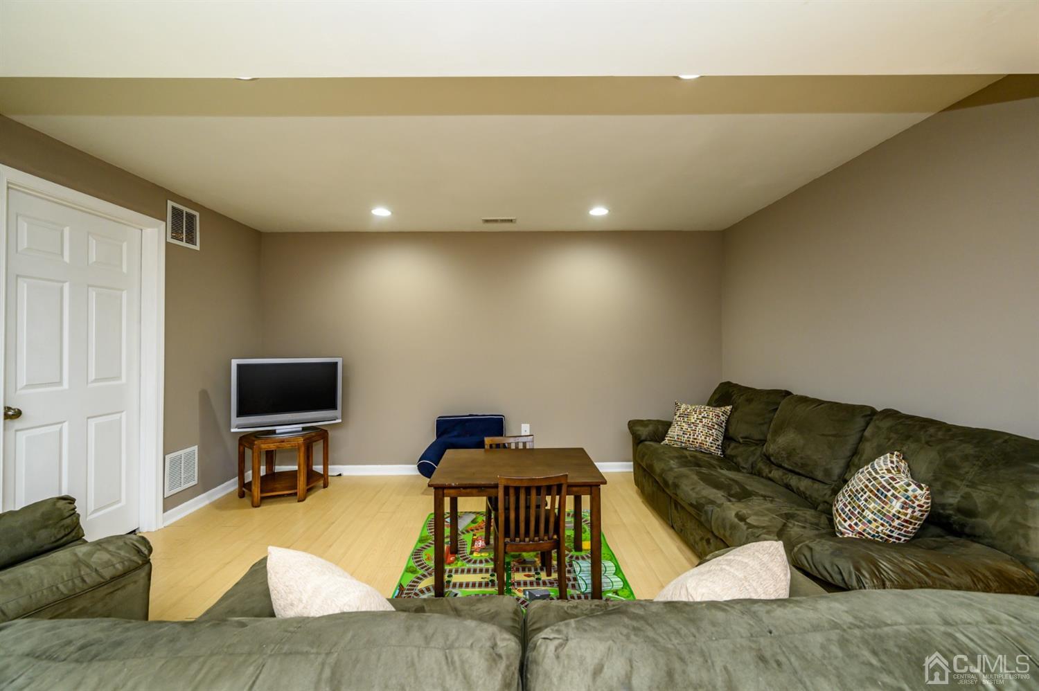 65 Lamp Post Drive Barnegat, NJ 08005 - Photo 31 of 36 a living room with furniture and a flat screen tv