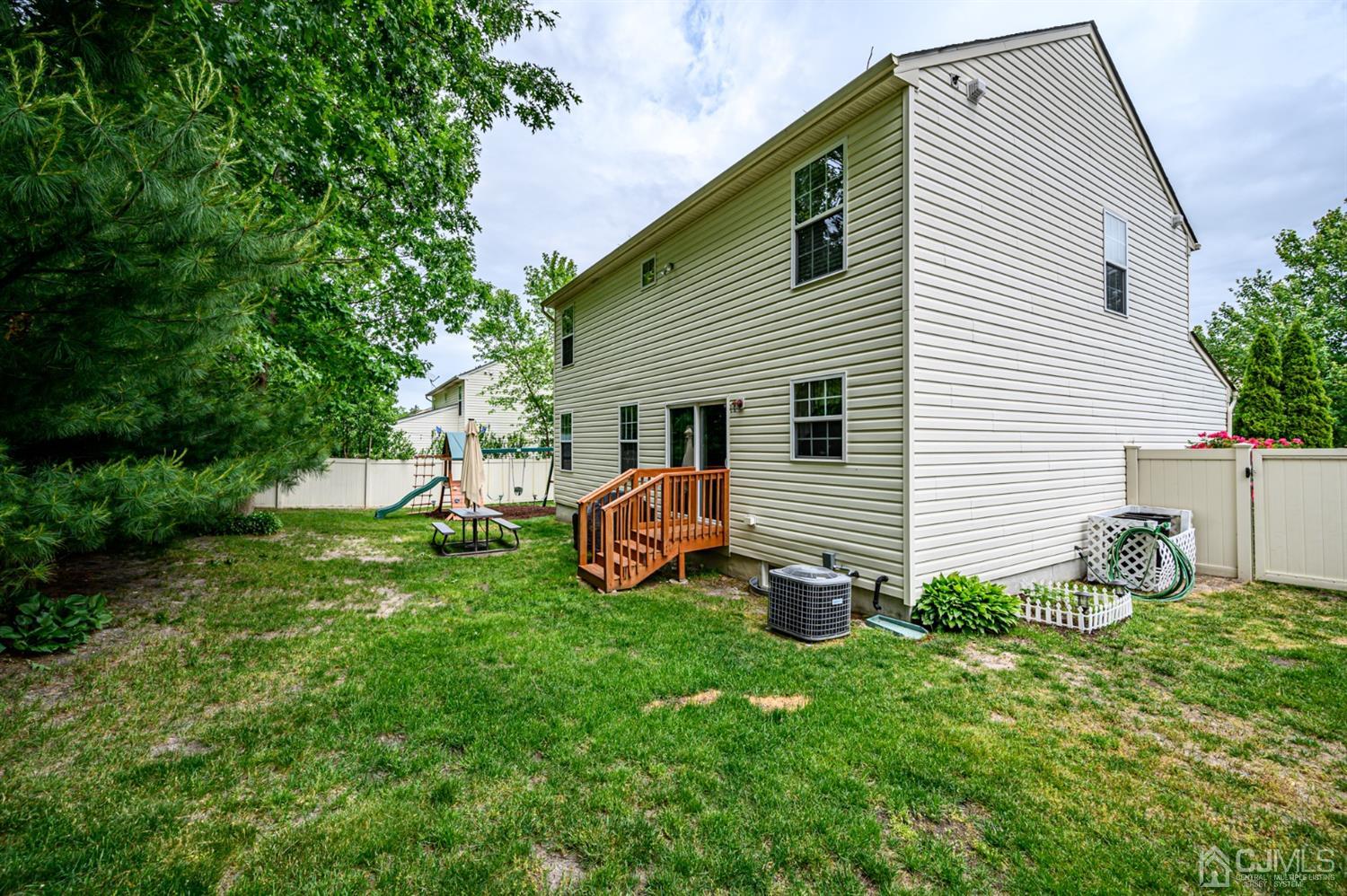 65 Lamp Post Drive Barnegat, NJ 08005 - Photo 32 of 36 a view of a chair and table in backyard of the house