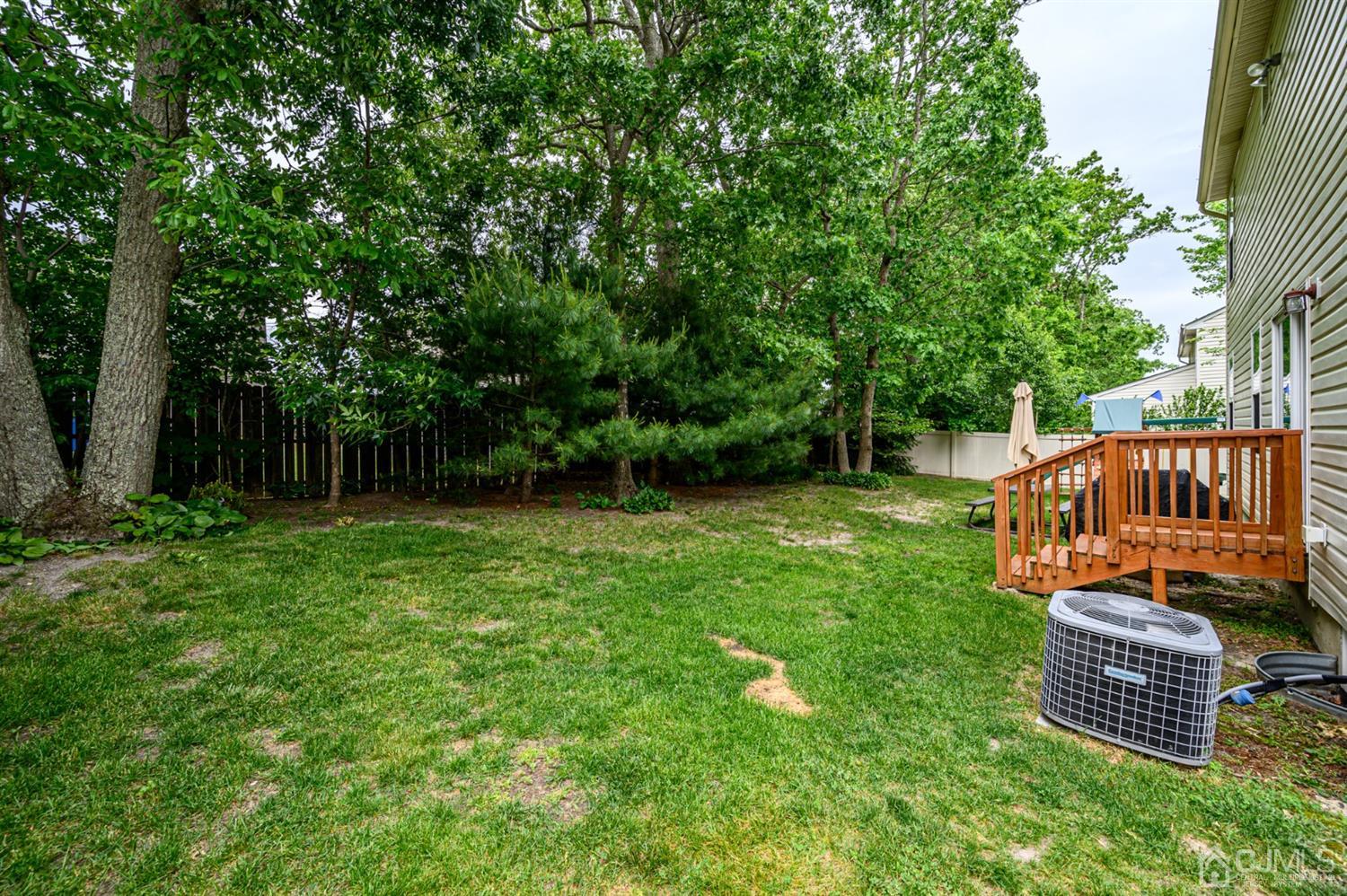 65 Lamp Post Drive Barnegat, NJ 08005 - Photo 33 of 36 a view of a backyard with wooden fence and a bench