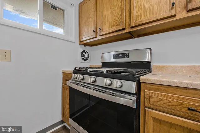 a stove top oven sitting inside of a kitchen
