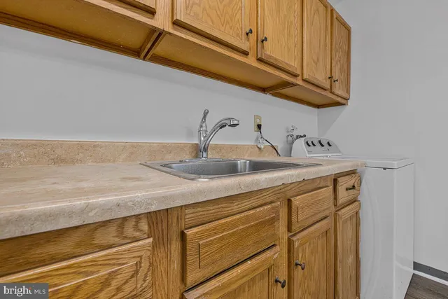 a kitchen with a sink and cabinets