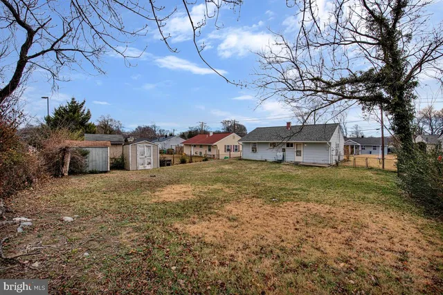 a yellow house with trees in front of it
