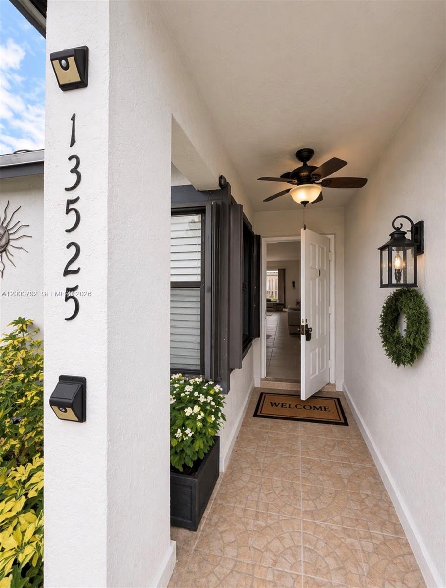 13525 Southwest 115th Place Miami, FL 33176 - Photo 1 of 10 a view of hallway with chandelier and a potted plant