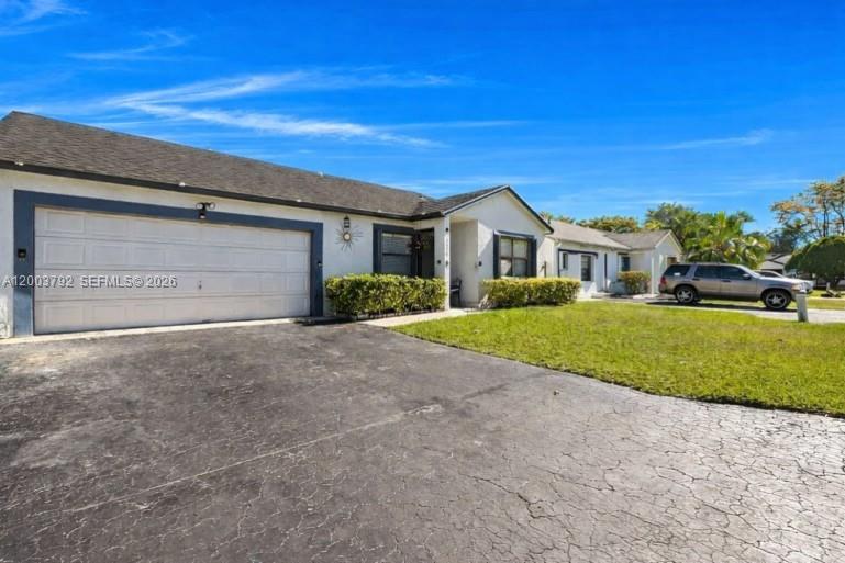 13525 Southwest 115th Place Miami, FL 33176 - Photo 2 of 10 a view of house in front of a big yard with large trees