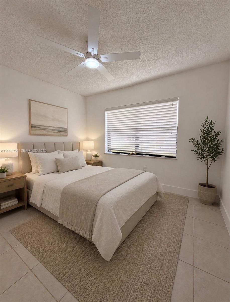 13525 Southwest 115th Place Miami, FL 33176 - Photo 5 of 10 a bedroom with a bed and a potted plant