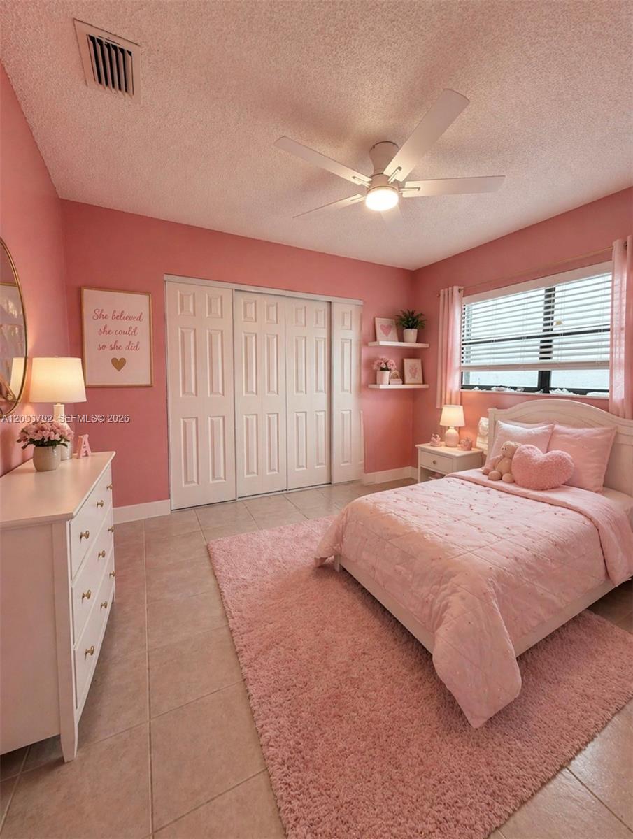 13525 Southwest 115th Place Miami, FL 33176 - Photo 7 of 10 a bedroom with a large bed and a chandelier