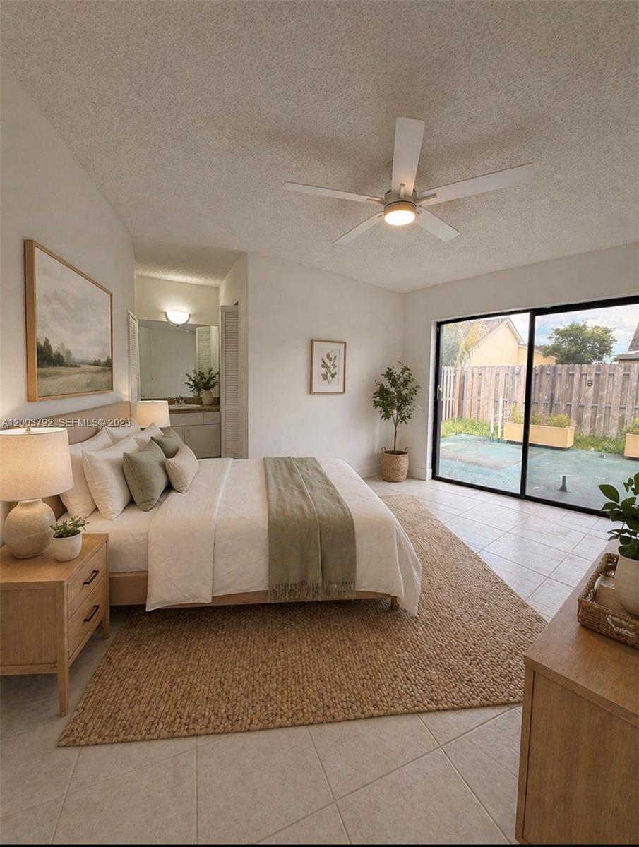13525 Southwest 115th Place Miami, FL 33176 - Photo 8 of 10 a spacious bedroom with a large bed and a couch