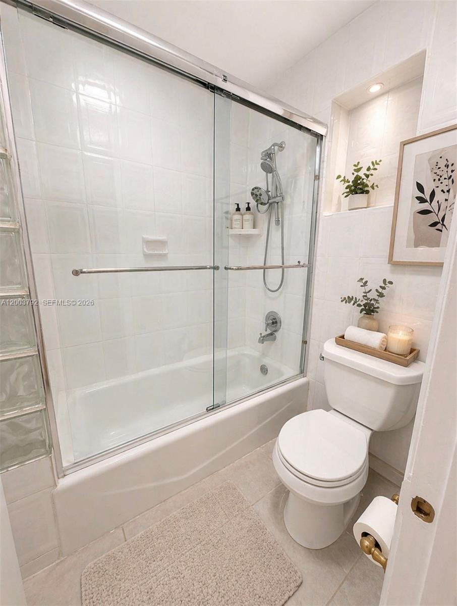13525 Southwest 115th Place Miami, FL 33176 - Photo 9 of 10 a white toilet sitting next to a bath tub and a shower