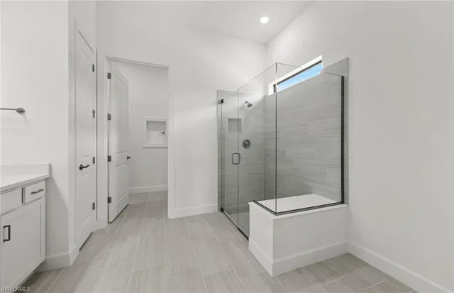 a bathroom with a shower and a sink