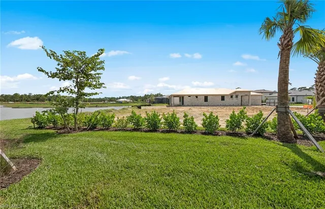 a view of a garden with a building in the background