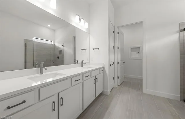 a spacious bathroom with a double vanity sink mirror double and shower