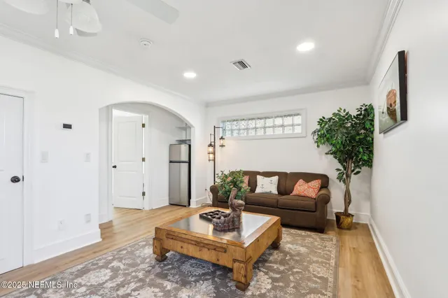 a view of a dining room with furniture a chandelier and wooden floor