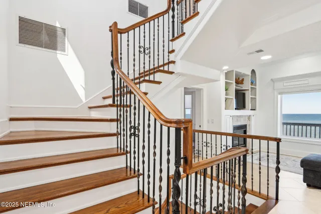 a view of a dining room with furniture a chandelier and wooden floor
