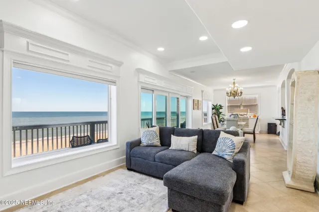 a large white kitchen with stainless steel appliances granite countertop a stove and a sink