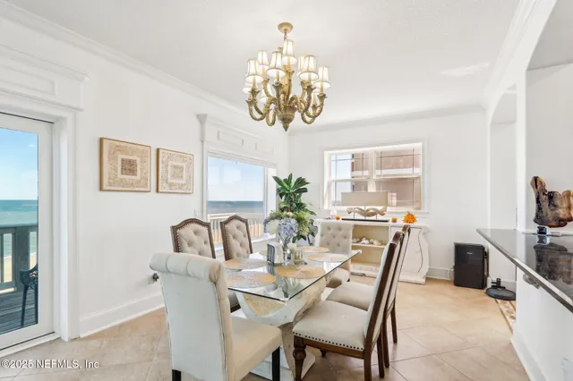 a kitchen with granite countertop a stove a sink and a chandelier