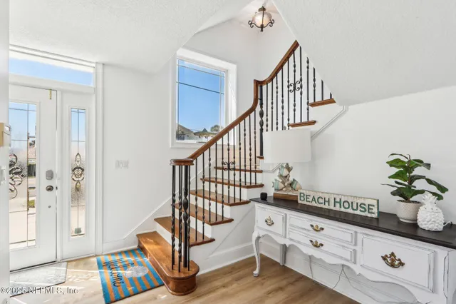 a living room with furniture a rug and a potted plant