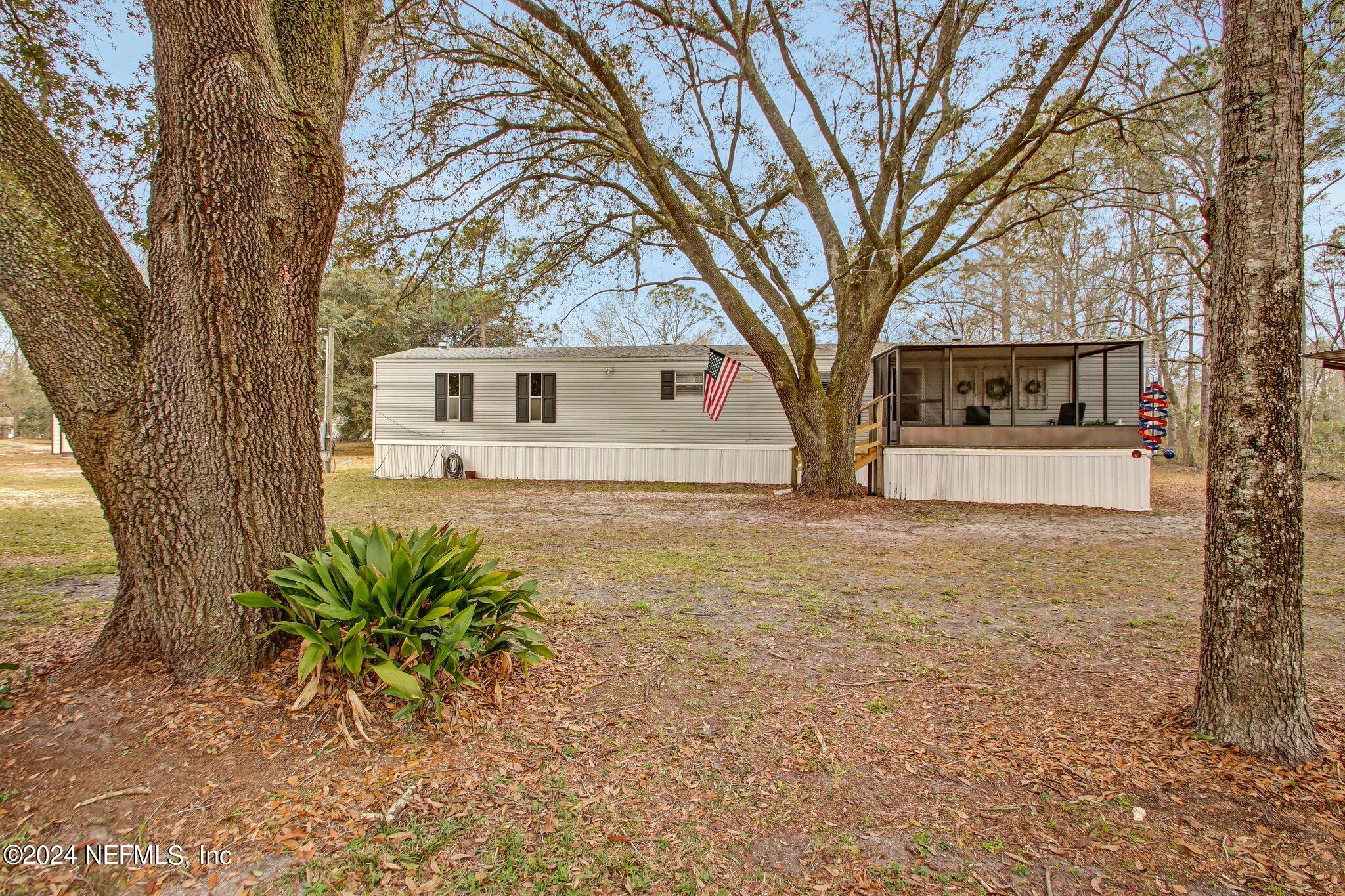 3996 Pinto Road Middleburg, FL 32068 - Photo 1 of 26 a front view of house with yard and trees around