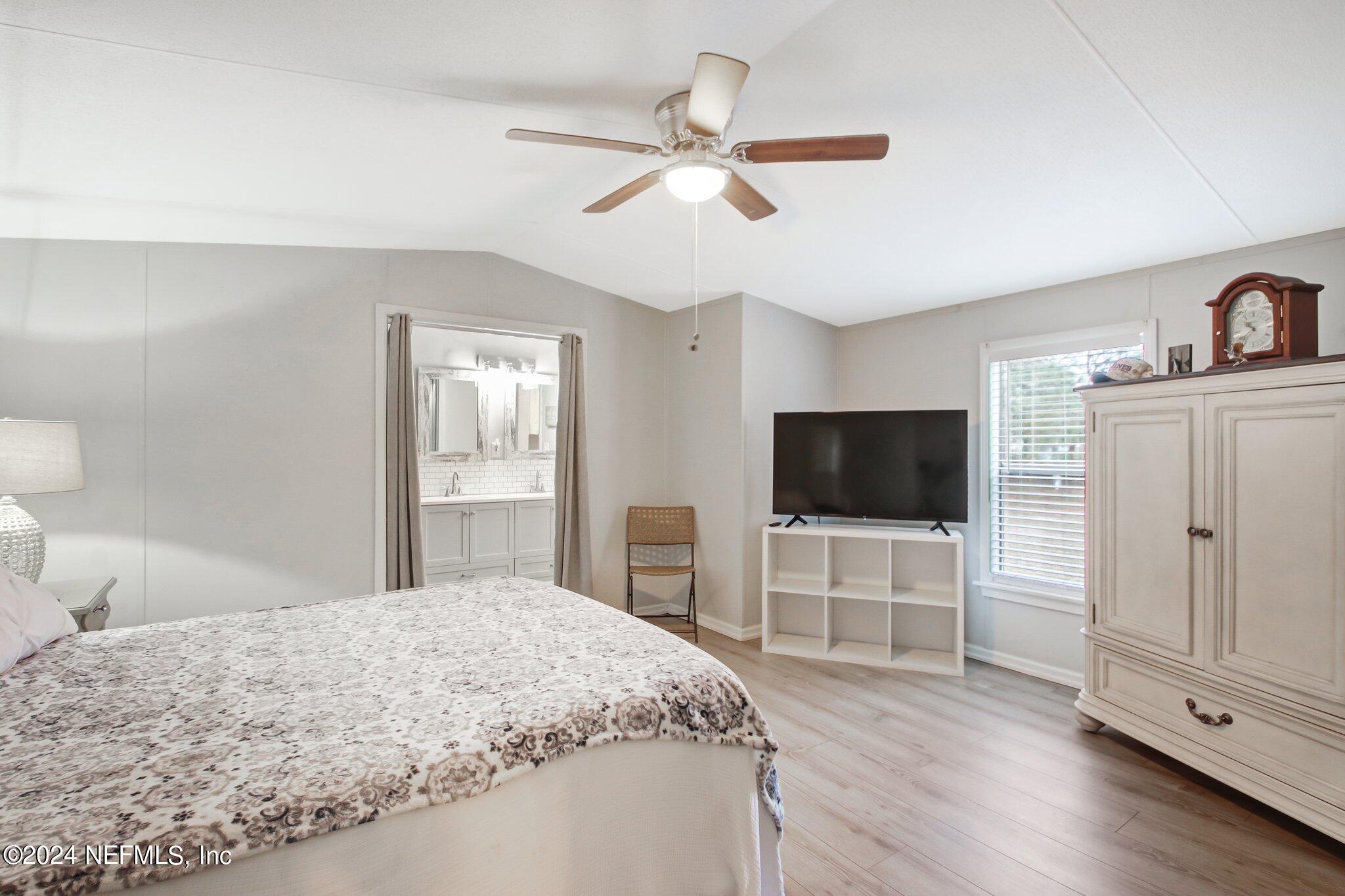 3996 Pinto Road Middleburg, FL 32068 - Photo 17 of 26 a bedroom with a bed and a flat screen tv