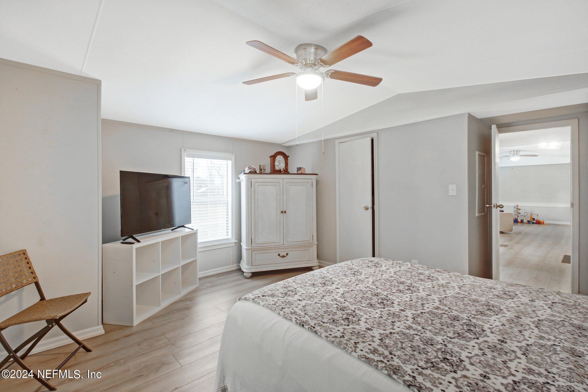 3996 Pinto Road Middleburg, FL 32068 - Photo 18 of 26 a bedroom with a bed and a flat screen tv