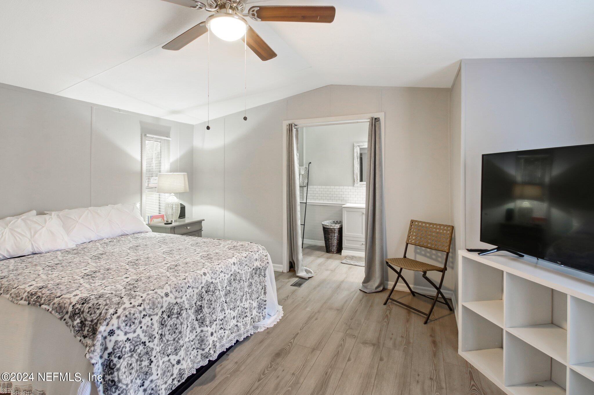 3996 Pinto Road Middleburg, FL 32068 - Photo 19 of 26 a bedroom with a bed and a flat screen tv