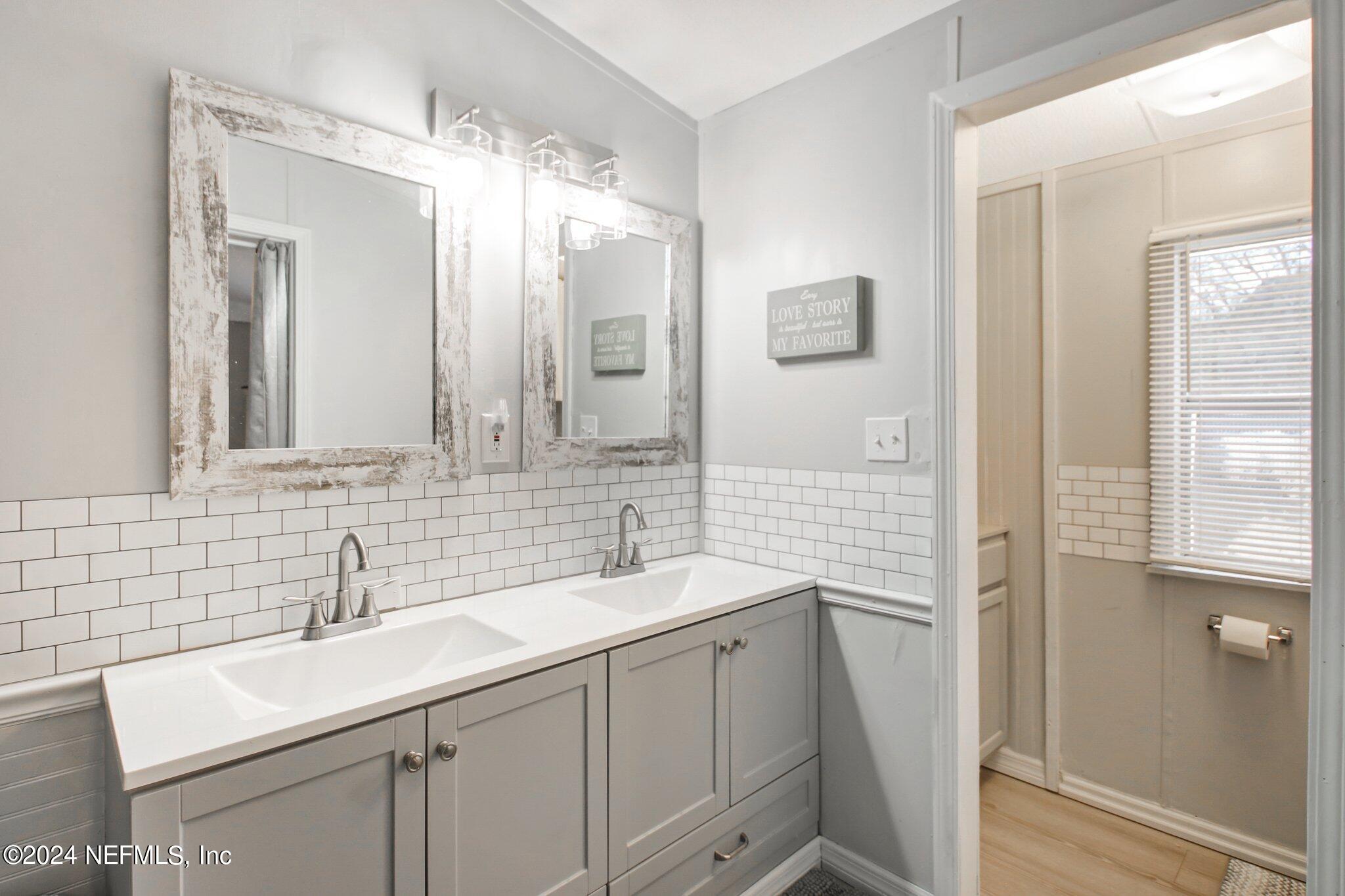 3996 Pinto Road Middleburg, FL 32068 - Photo 20 of 26 a bathroom with a sink double vanity and a mirror