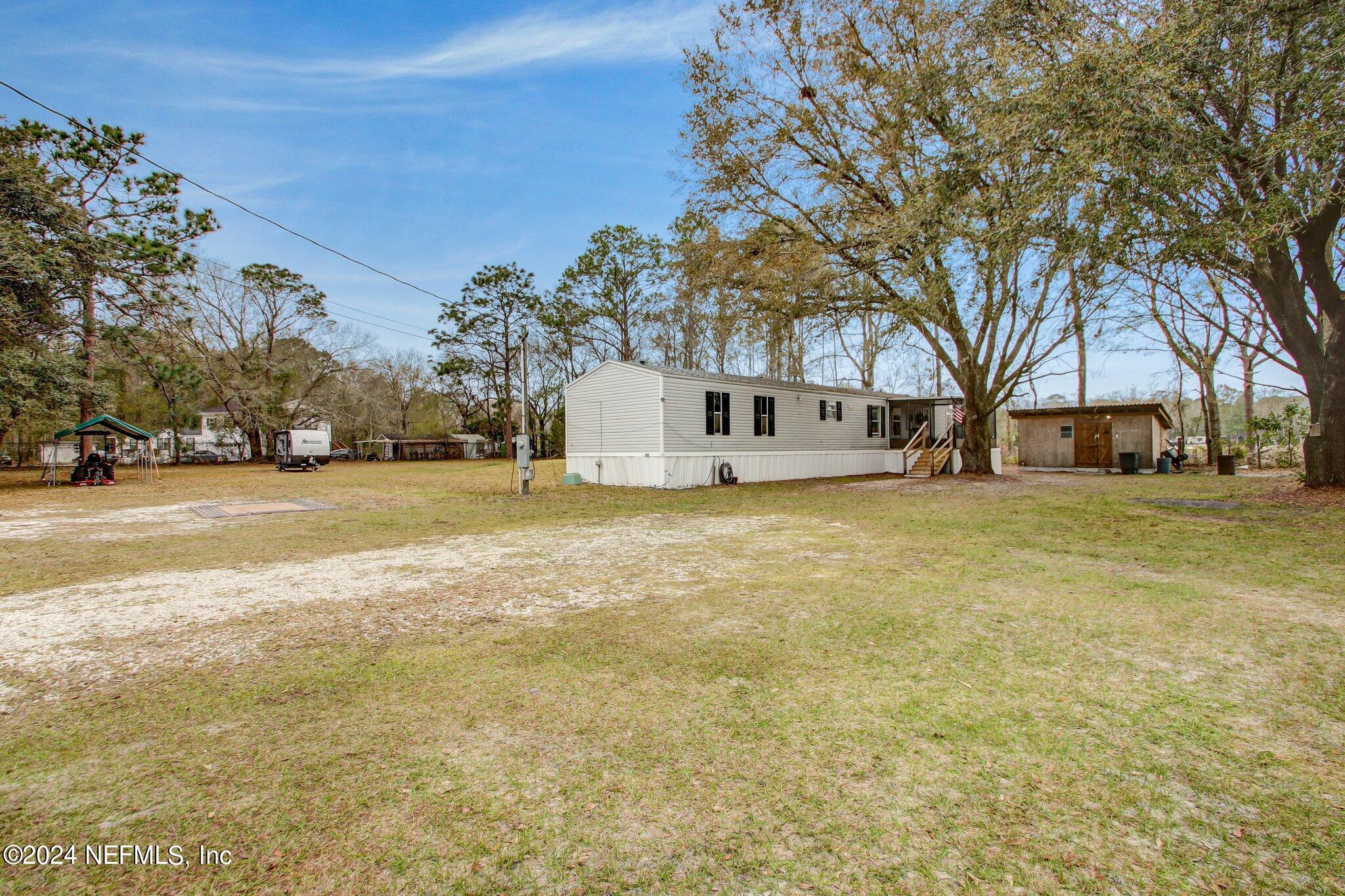 3996 Pinto Road Middleburg, FL 32068 - Photo 2 of 26 a view of a town with large trees