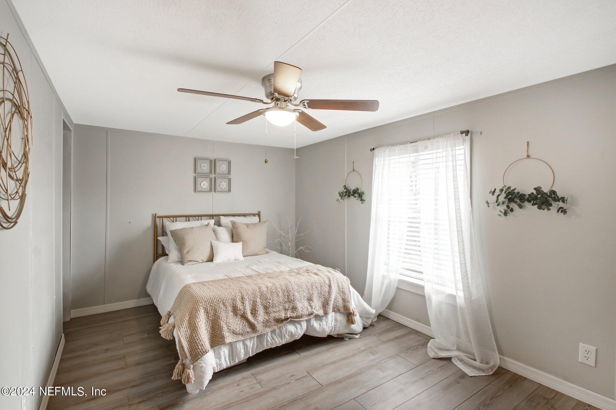 3996 Pinto Road Middleburg, FL 32068 - Photo 21 of 26 a bedroom with a bed and a window