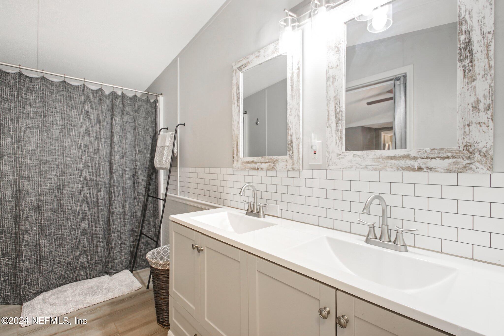 3996 Pinto Road Middleburg, FL 32068 - Photo 22 of 26 a bathroom with a sink a toilet and shower