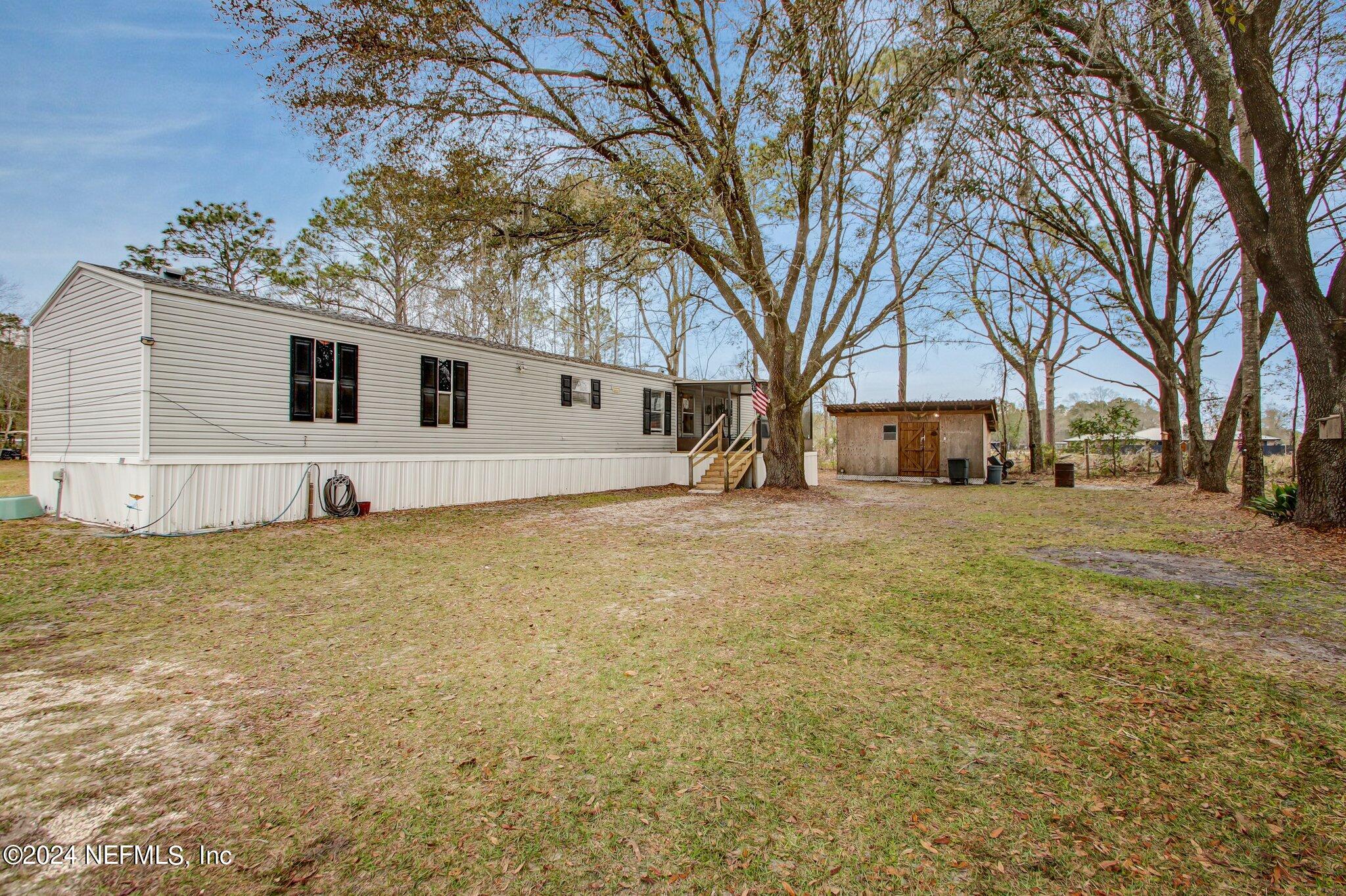 3996 Pinto Road Middleburg, FL 32068 - Photo 3 of 26 a white house that has a tree in front of it