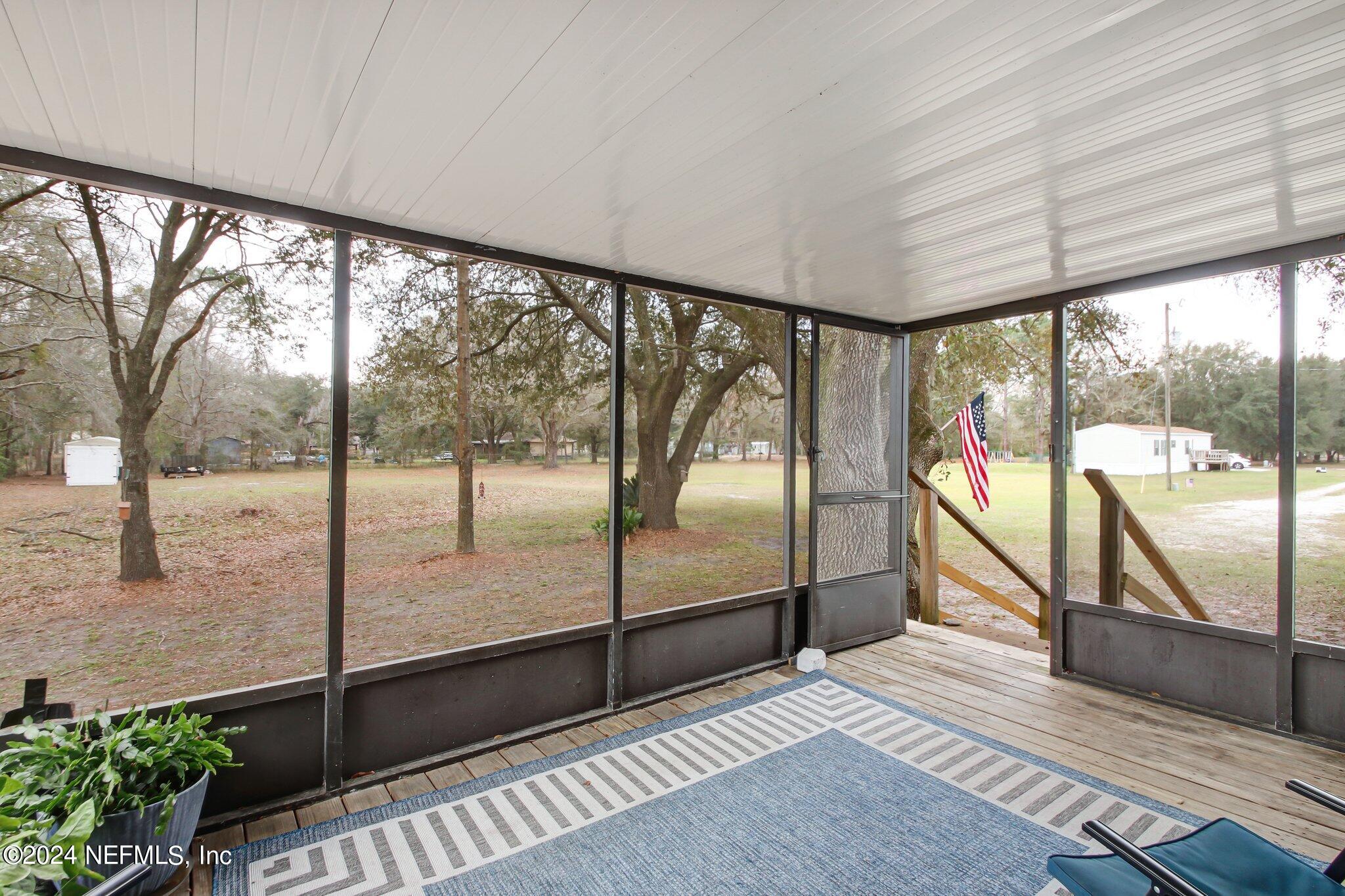 3996 Pinto Road Middleburg, FL 32068 - Photo 7 of 26 a view of a room with wooden floor and iron stairs