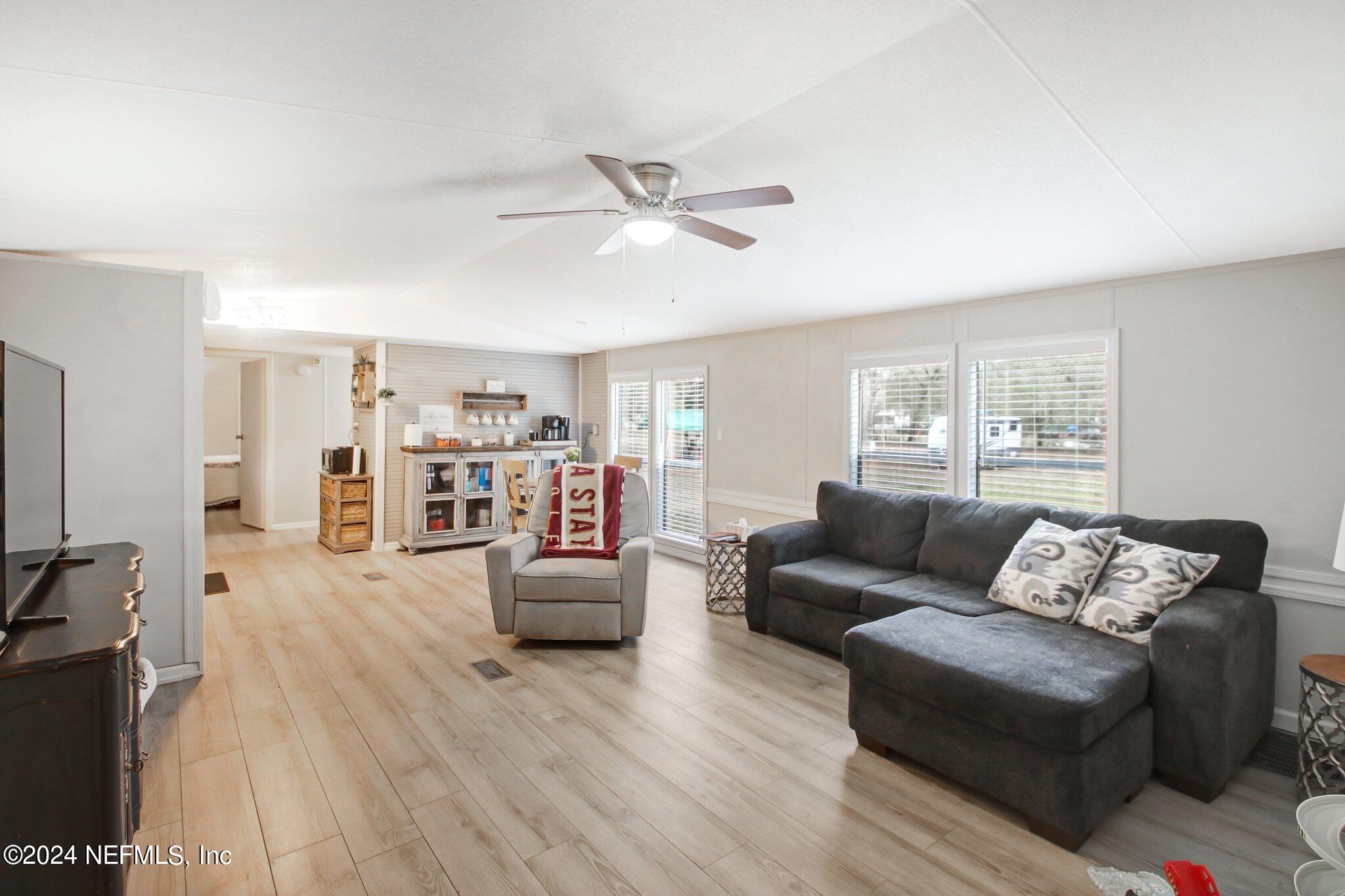 3996 Pinto Road Middleburg, FL 32068 - Photo 8 of 26 a living room with furniture and a wooden floor