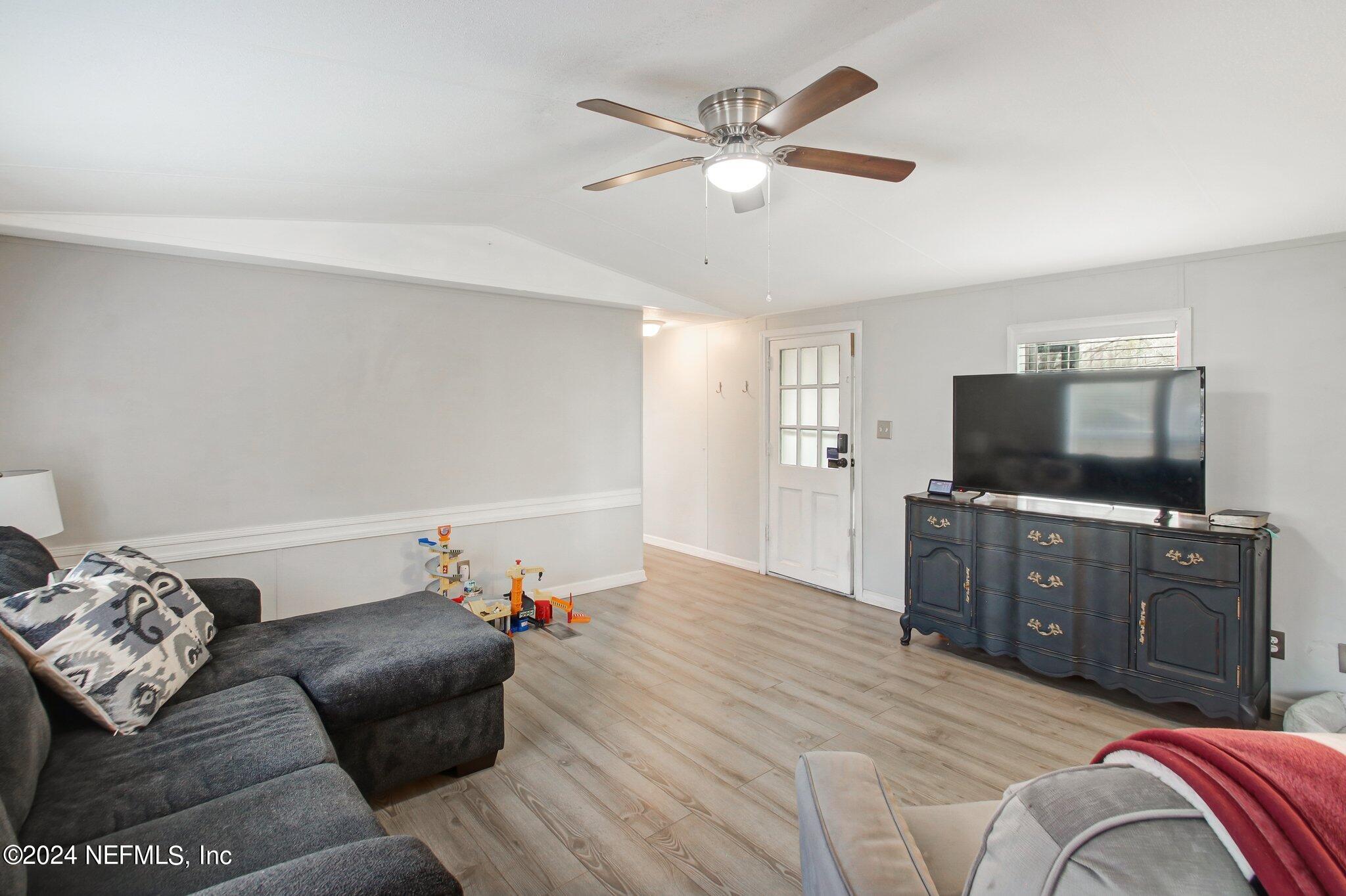 3996 Pinto Road Middleburg, FL 32068 - Photo 10 of 26 a bedroom with a bed and a flat screen tv