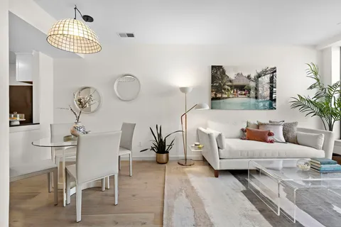 a view of a dining room with furniture and a chandelier
