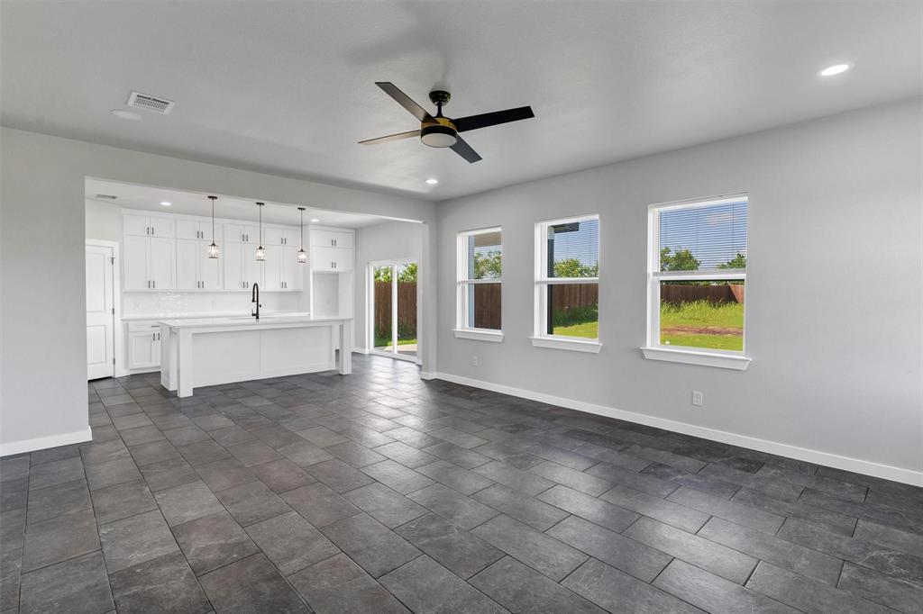 576 Highview Court Godley, TX 76044 - Photo 11 of 40 a view of an empty room with a window and kitchen view