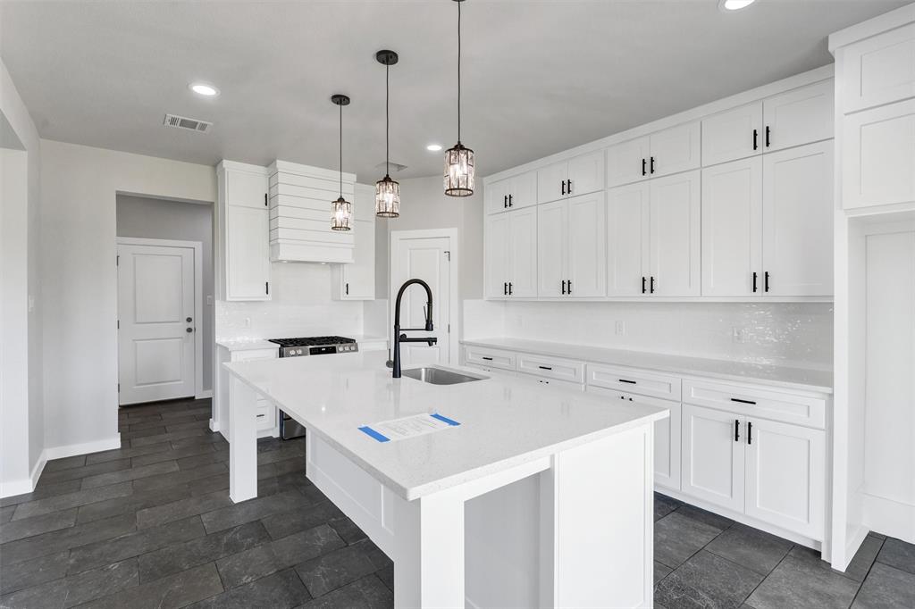576 Highview Court Godley, TX 76044 - Photo 13 of 40 a kitchen that has a lot of cabinets in it