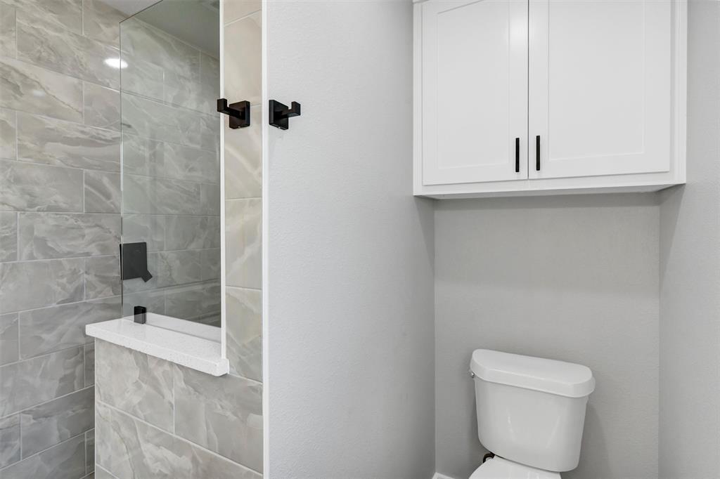 576 Highview Court Godley, TX 76044 - Photo 27 of 40 a bathroom with a toilet sink and mirror