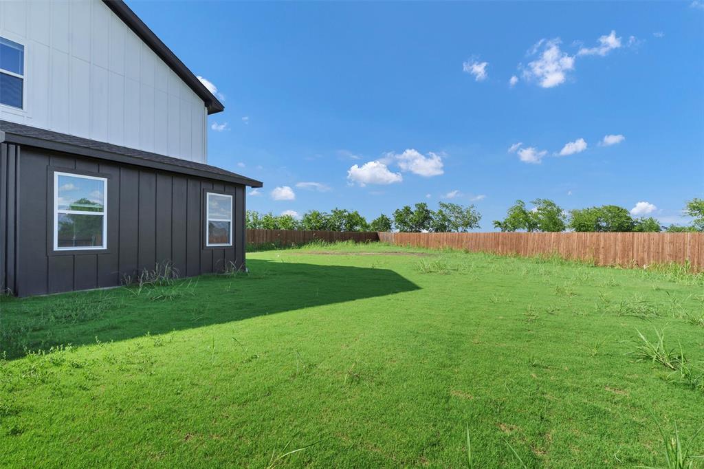 576 Highview Court Godley, TX 76044 - Photo 36 of 40 a view of a backyard with potted plants and wooden fence