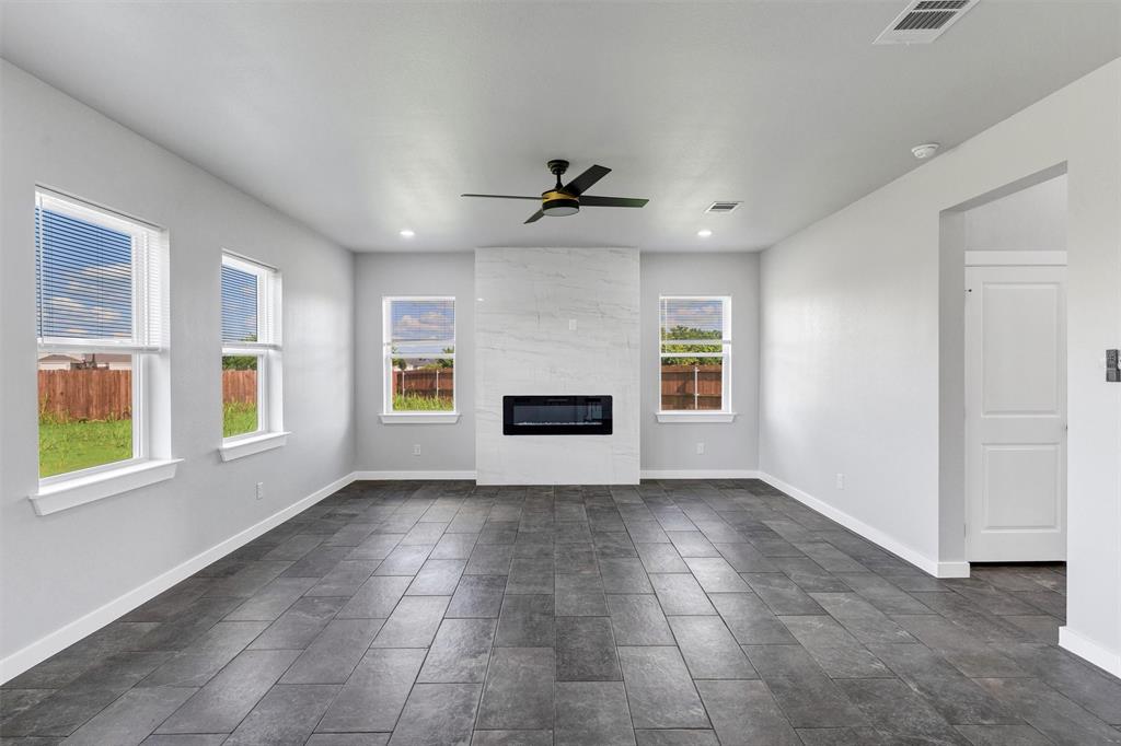 576 Highview Court Godley, TX 76044 - Photo 8 of 40 an empty room with windows and fireplace